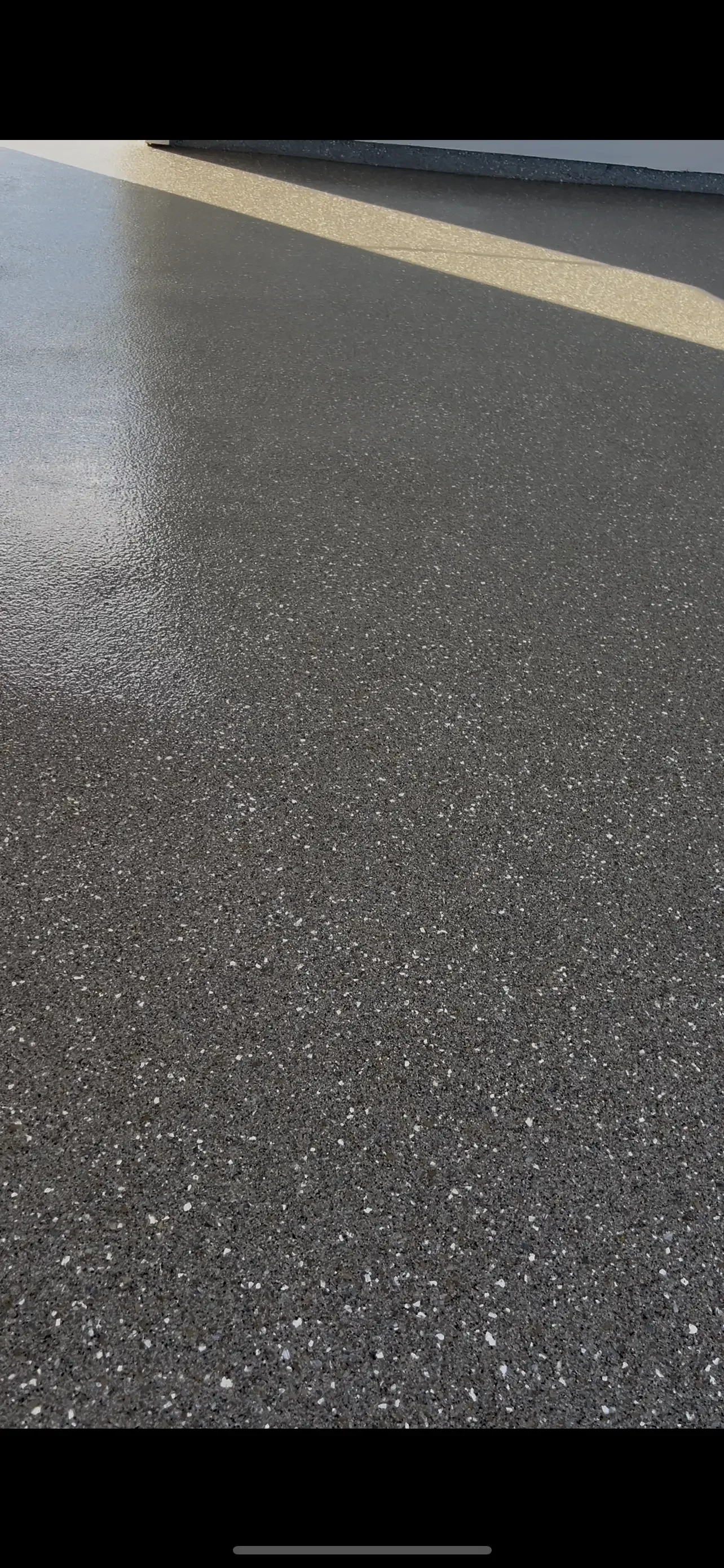 Polished concrete floor with aggregate finish and yellow stripe detail