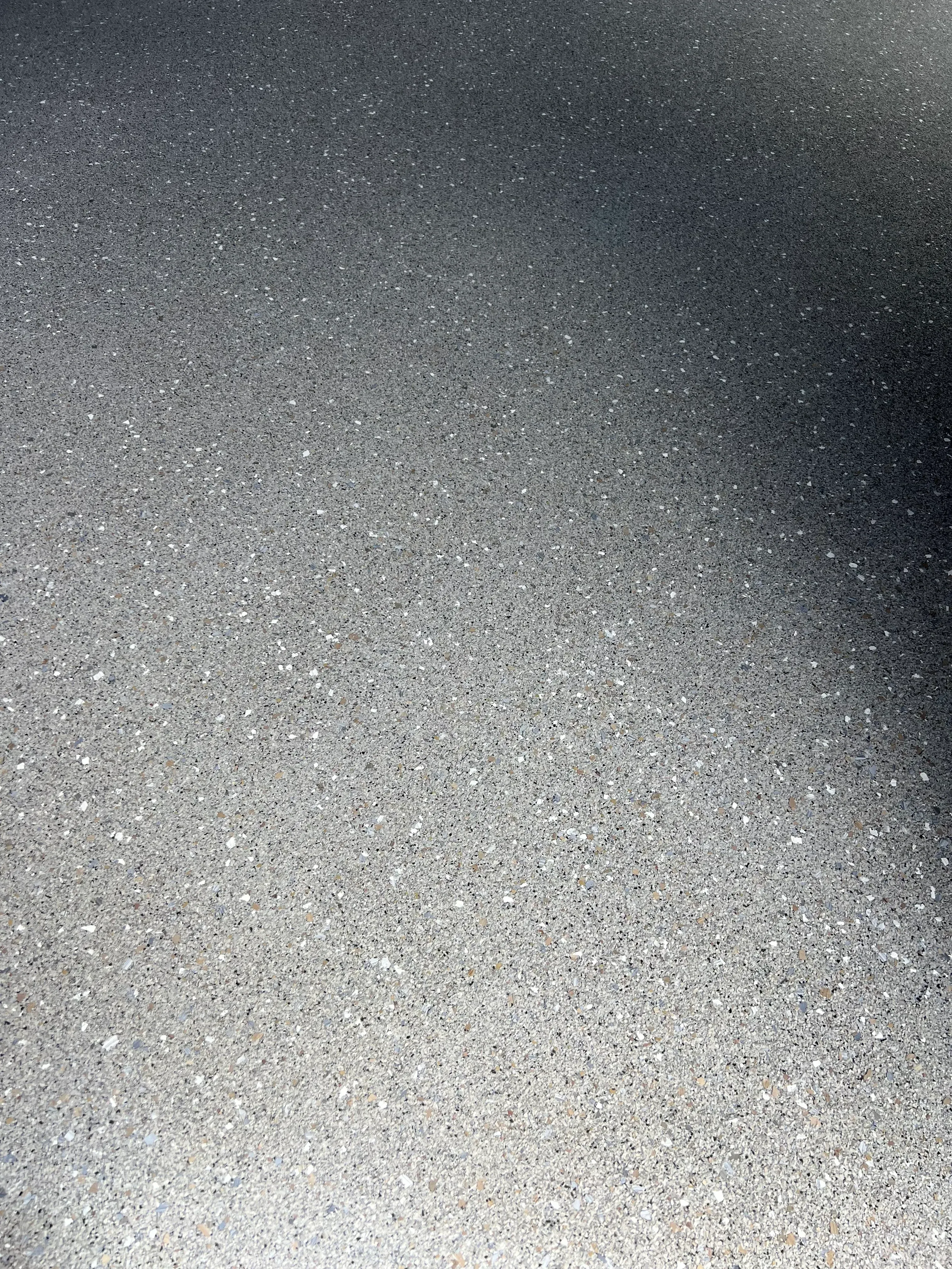 Polished concrete floor with exposed aggregate and gradient finish from dark to light