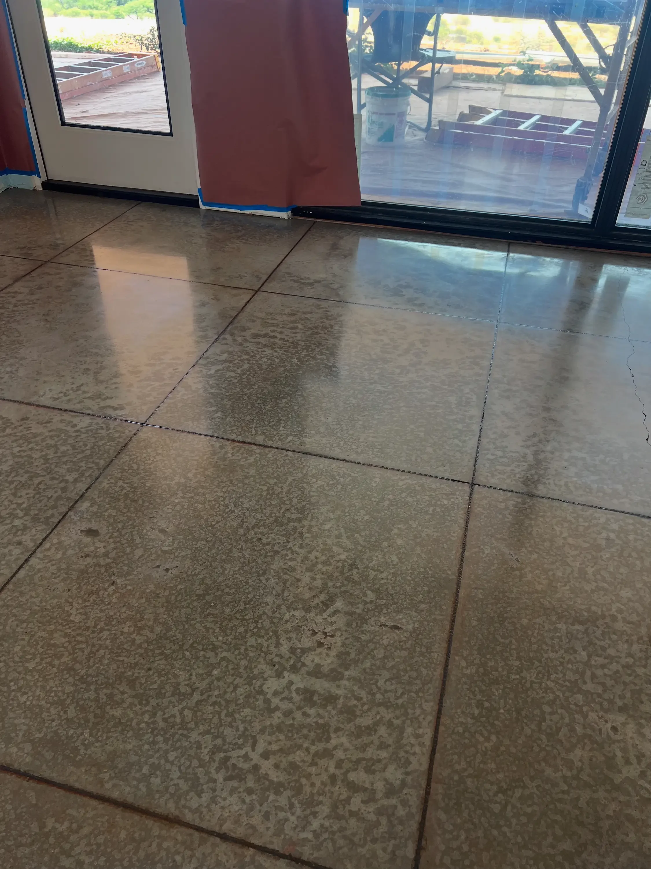 Polished concrete floor with control joints and reflective finish in commercial space