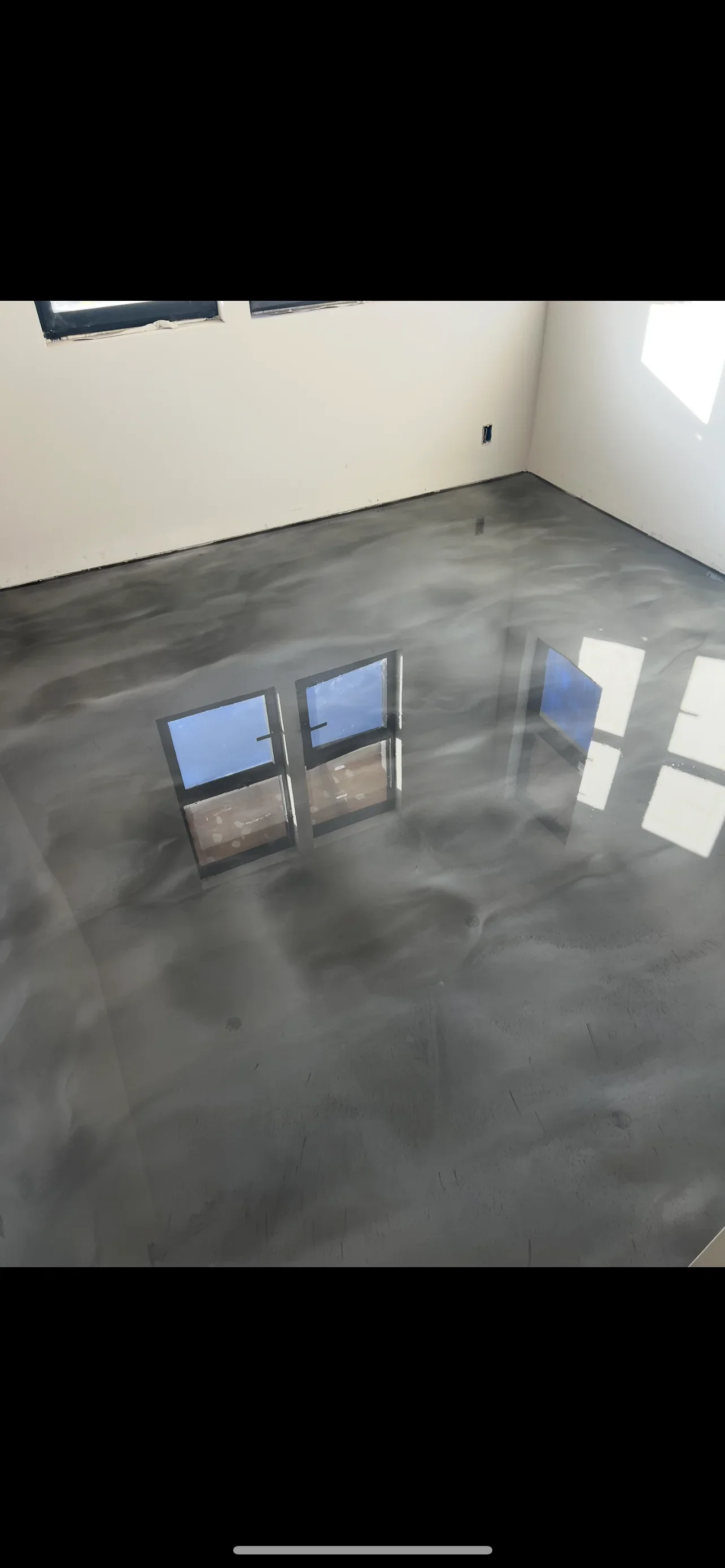 Polished concrete floor with light gray finish and natural aggregate in residential room